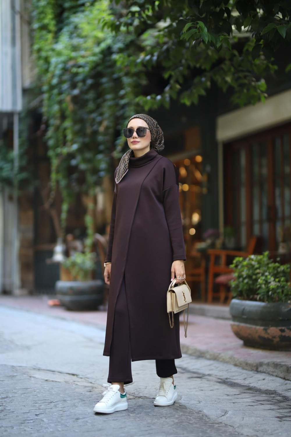 Three-quarter front view of the dark plum MODESTIQUE Luna Set, showing the overlapping tunic front and matching pants.