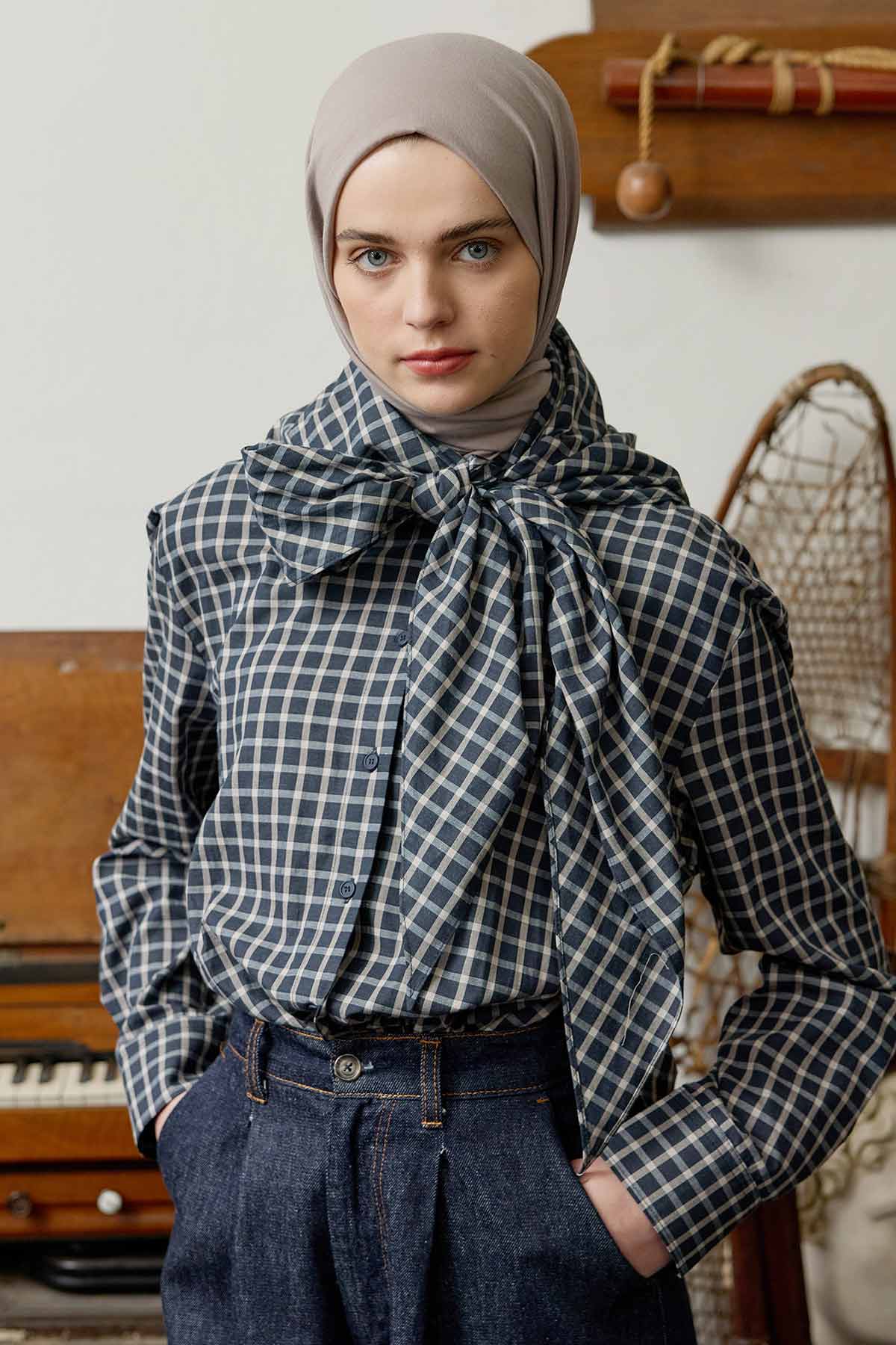 Woman wearing the taupe Comfort Cotton Hijab with a houndstooth blouse and bow