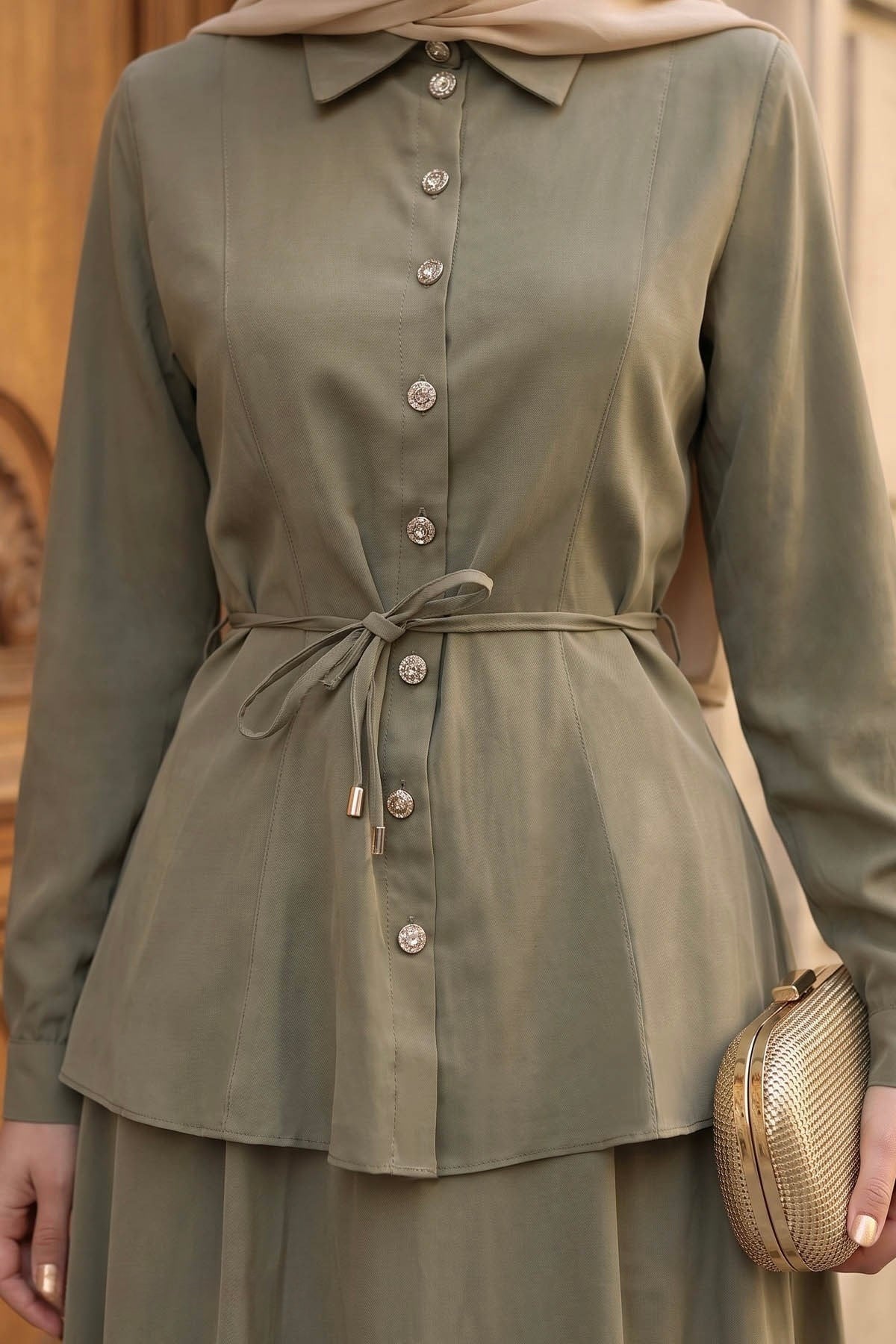 Close-up of the Ayla skirt set in sage showing the button-front shirt and tie waist