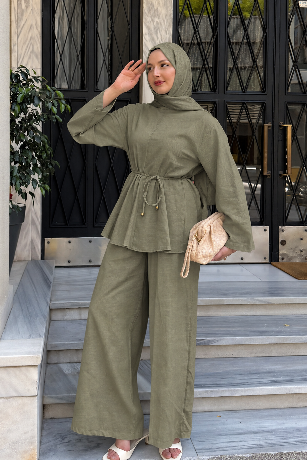 Woman in a hijab wearing the Willow cotton linen set in khaki green: tie-waist top and relaxed wide-leg pants