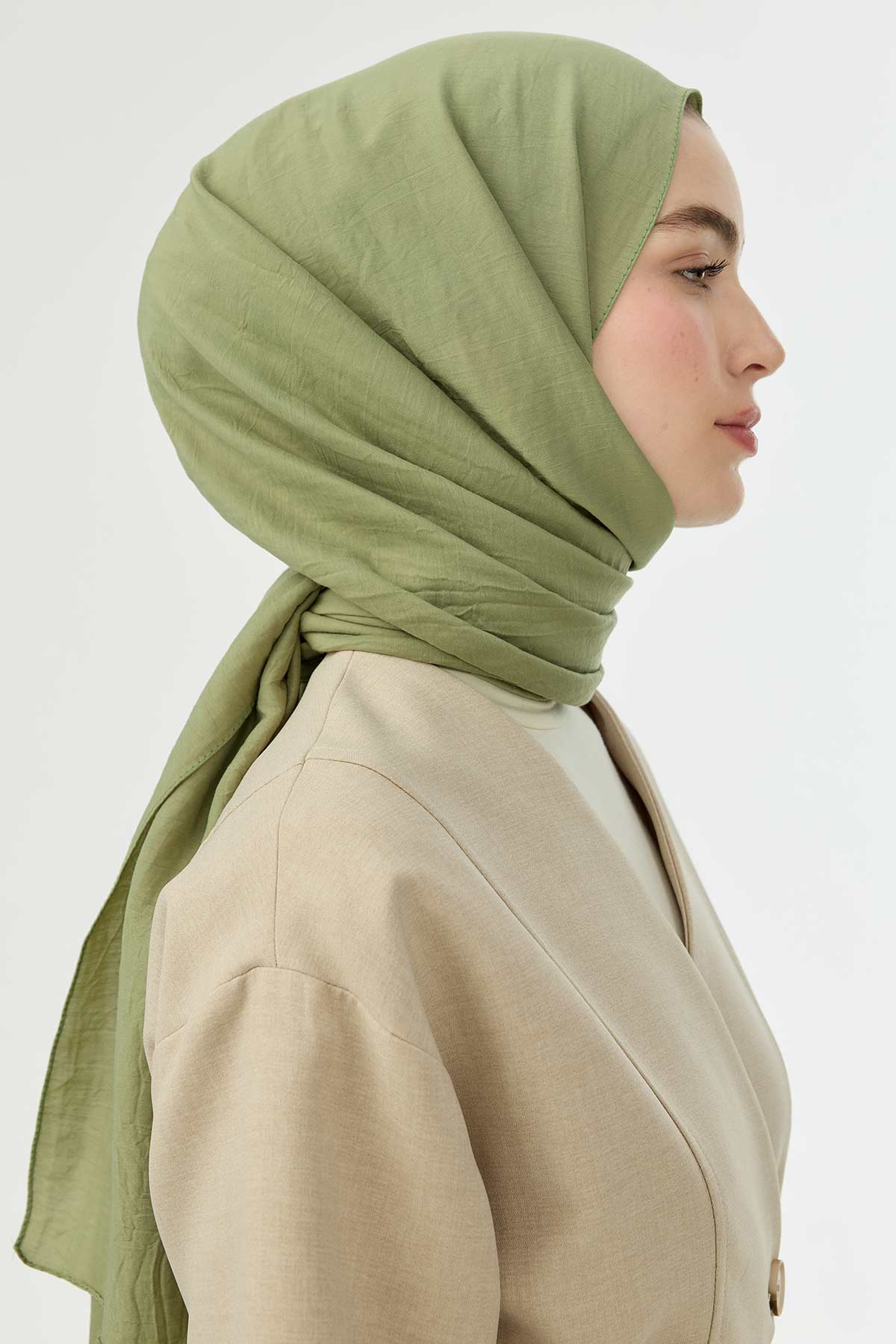 Pistachio Comfort Cotton Hijab shown in side profile with a beige top
