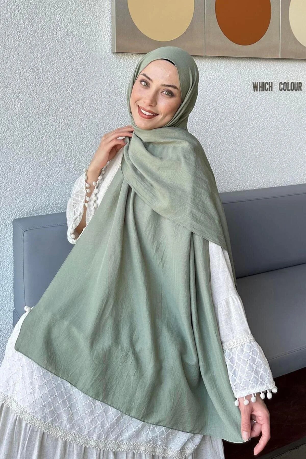 Woman in a sage green Comfort Cotton Hijab draped over a white dress, front view