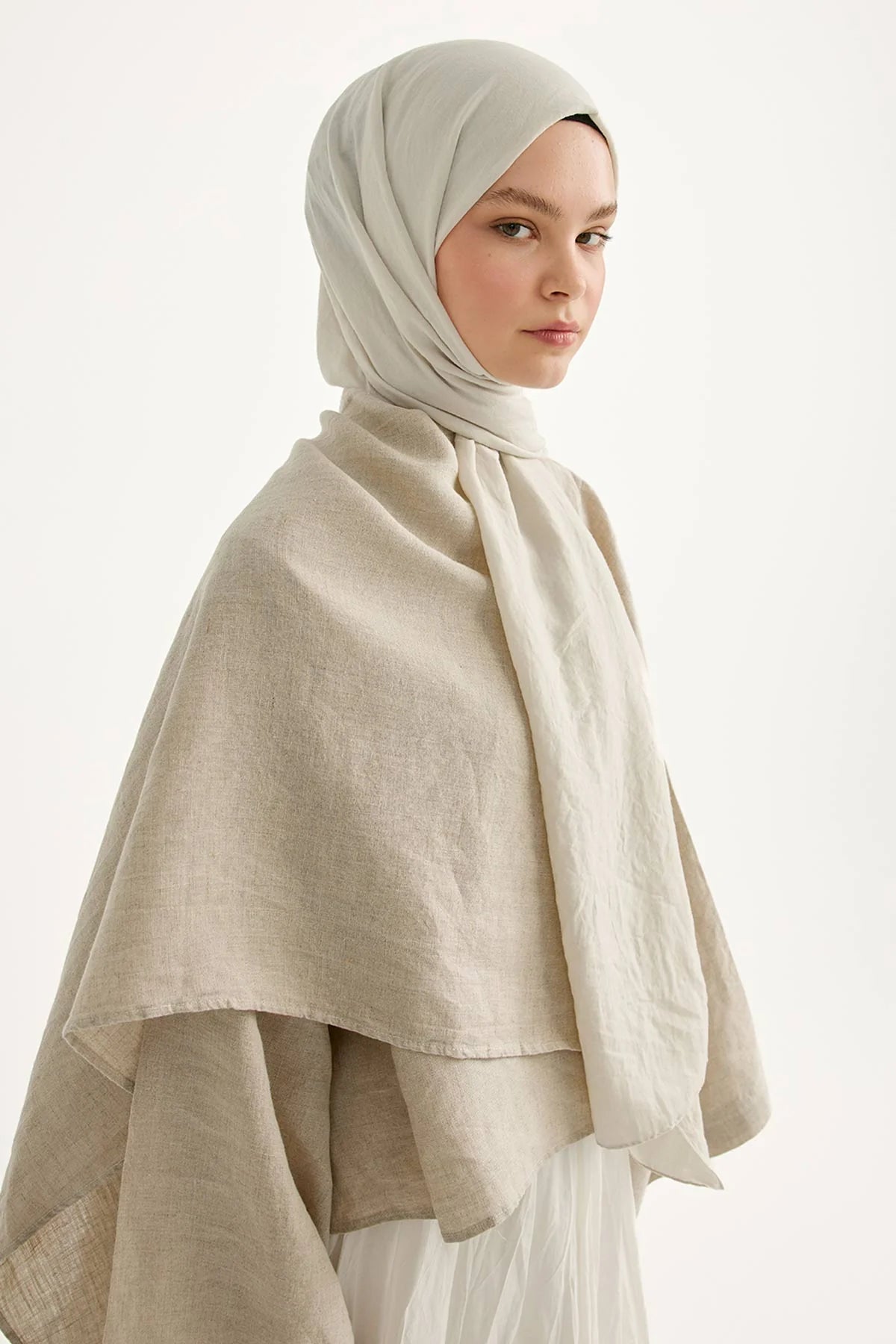 Woman wearing the bone Comfort Cotton Hijab with a long drape over a neutral wrap