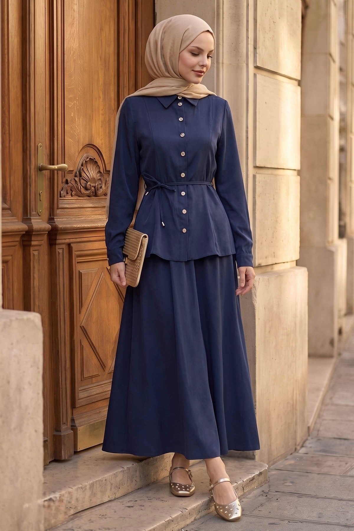 Ayla modest skirt set in navy with a woven clutch, full-length view