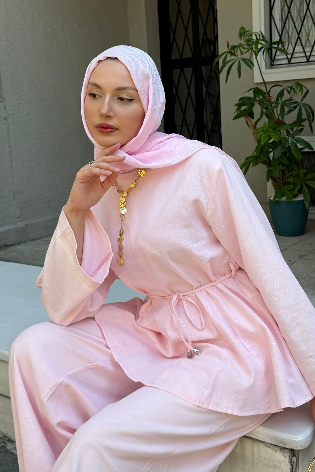 Willow linen set in pink with tie waist and relaxed pants, seated pose
