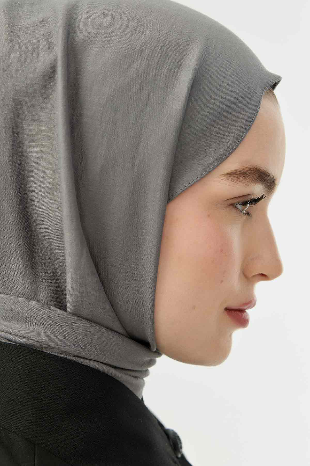 Close-up side profile of a woman wearing the grey Comfort Cotton Hijab