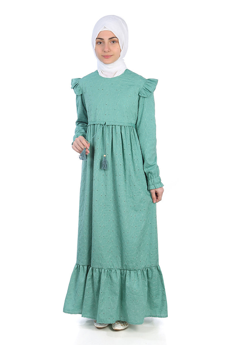 Model in a white hijab wearing the Dahlia girls' modest maxi dress in teal broderie anglaise, front view
