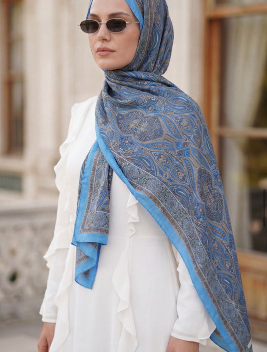 MODESTIQUE Bamboo Textured Print Hijab in Blue Oriental, worn with a white outfit and sunglasses.