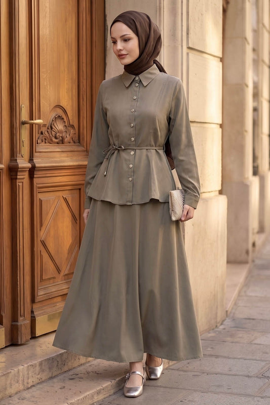 Woman in a hijab wearing the Ayla modest skirt set in taupe: tie-waist button-front shirt and A-line maxi skirt