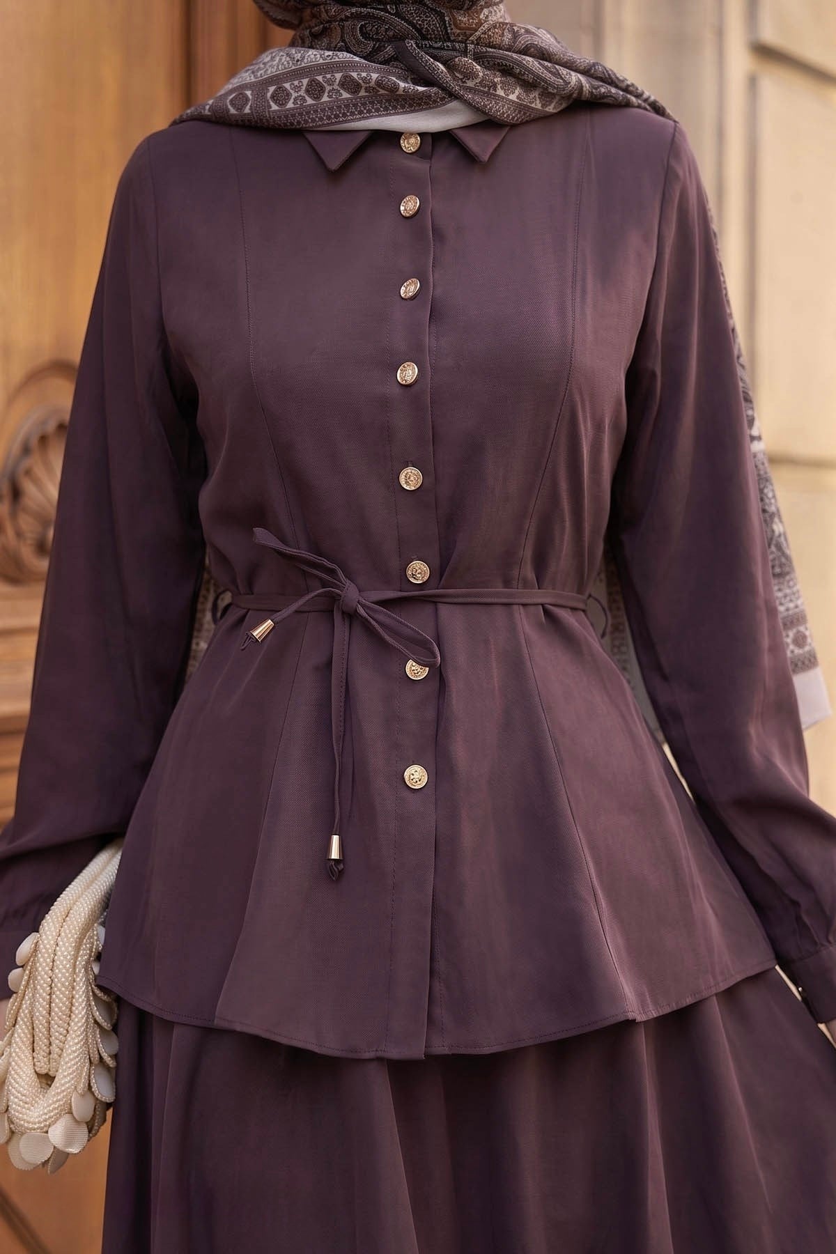 Close-up of the Ayla skirt set in burgundy showing the button-front shirt and tie waist