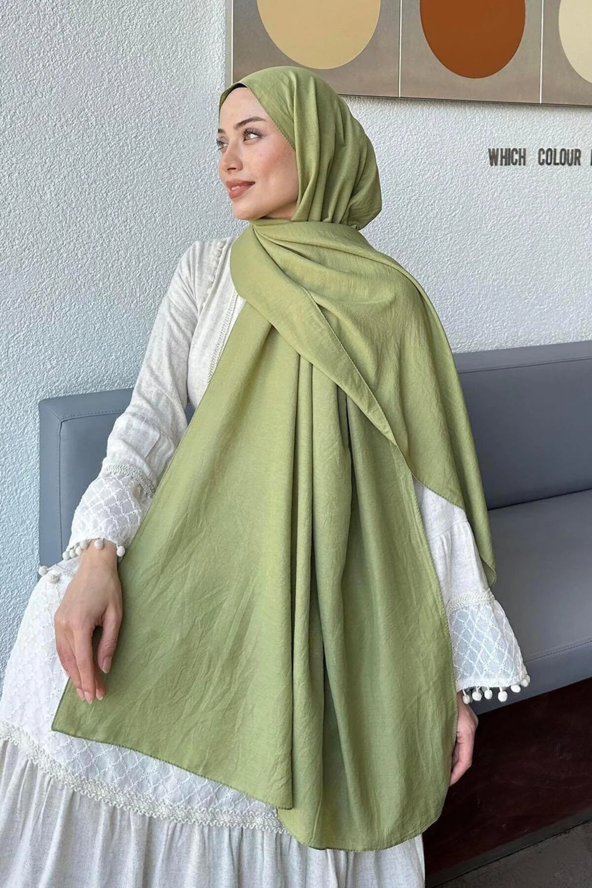 Model holding out the pistachio Comfort Cotton Hijab to show the full length