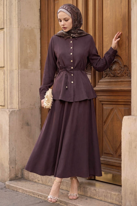 Woman in a hijab wearing the Ayla modest skirt set in burgundy: tie-waist button-front shirt and A-line maxi skirt