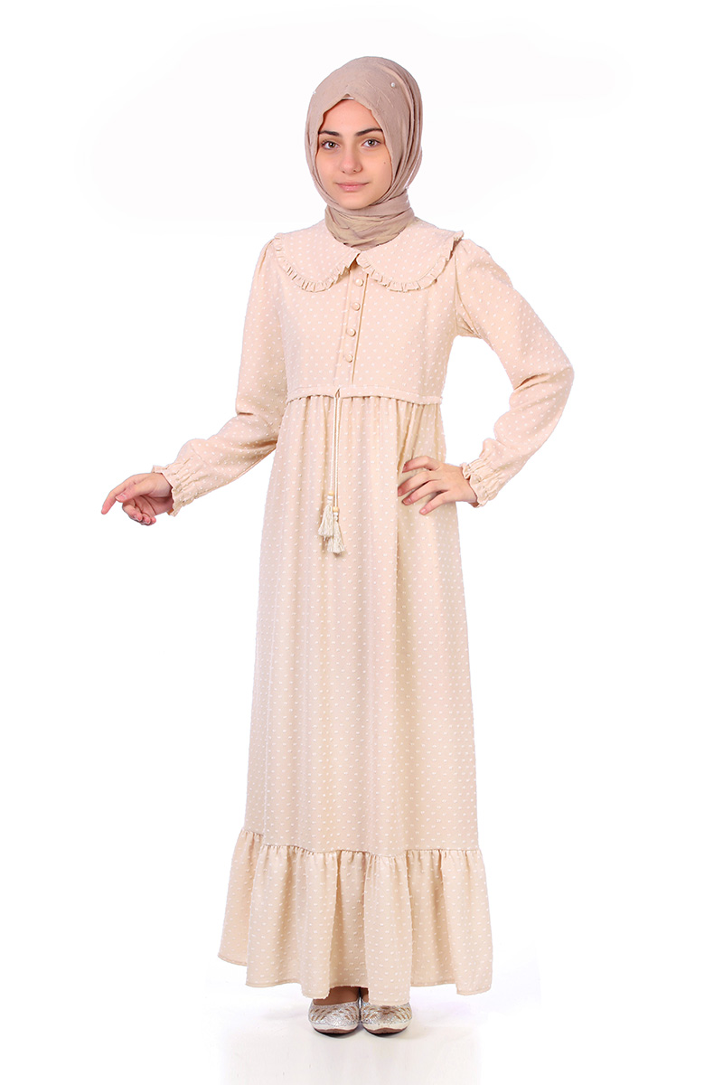 Model in a taupe hijab wearing the Zara girls' modest maxi dress in caramel polka dot with Peter Pan collar