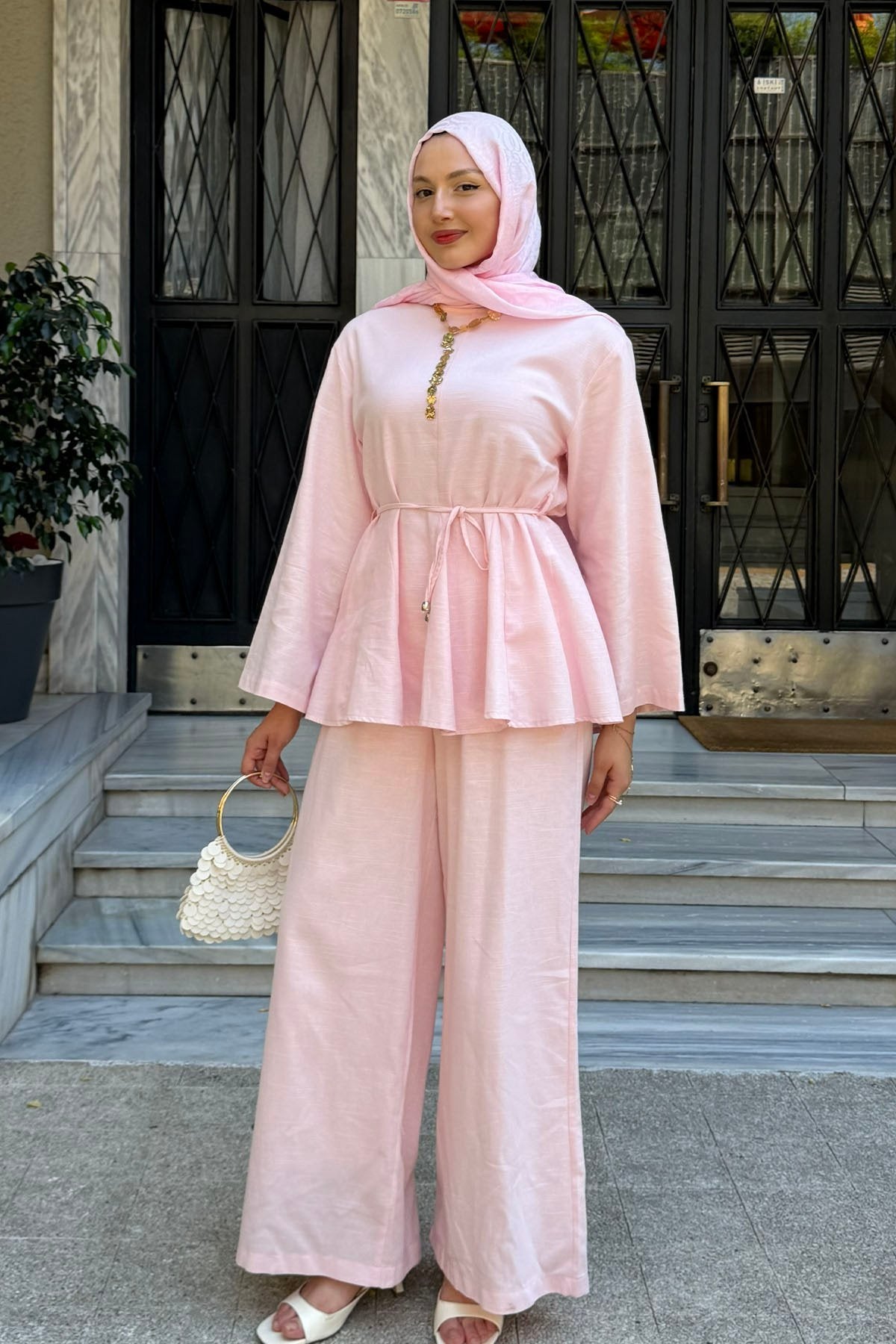 Willow linen set in pink styled with a small handbag, full-length view