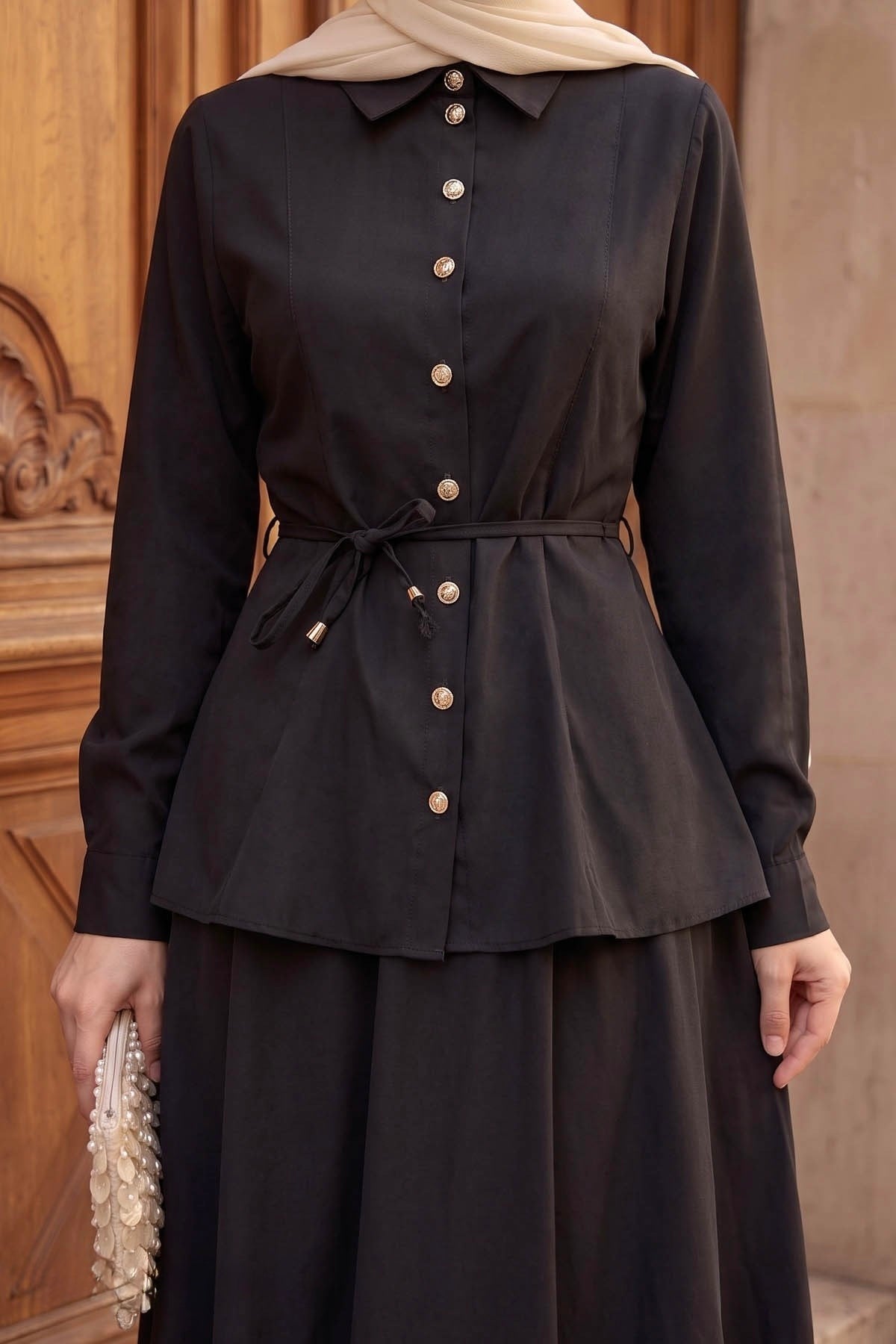 Close-up of the Ayla skirt set in black showing the button-front shirt and tie waist