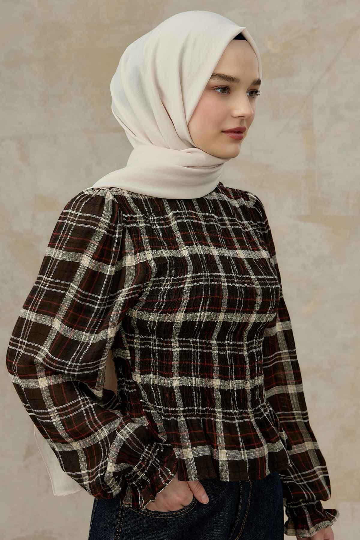 Ivory Comfort Cotton Hijab styled with a smocked plaid blouse, side view