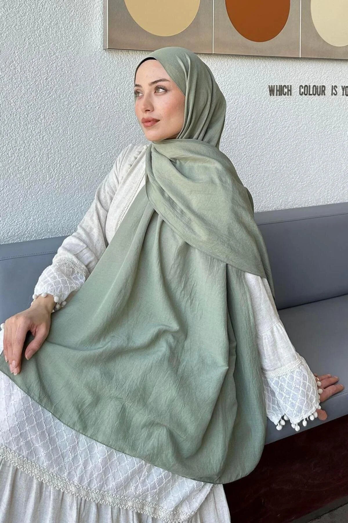 Model holding out the sage Comfort Cotton Hijab to show the full length
