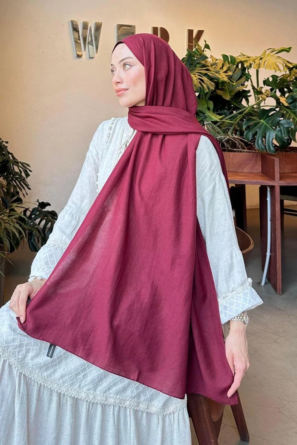 Model holding out the maroon Comfort Cotton Hijab to show the full length