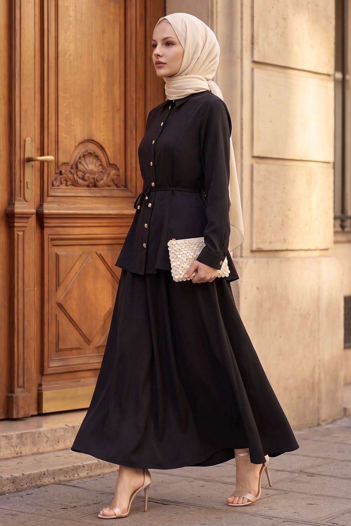 Woman walking in the Ayla modest skirt set in black with flowing A-line maxi skirt