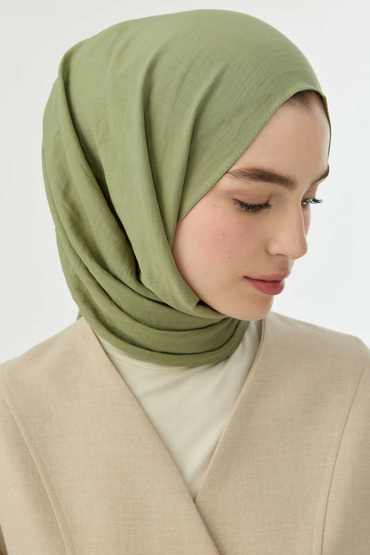 Close-up of the pistachio Comfort Cotton Hijab showing the soft wrapped drape