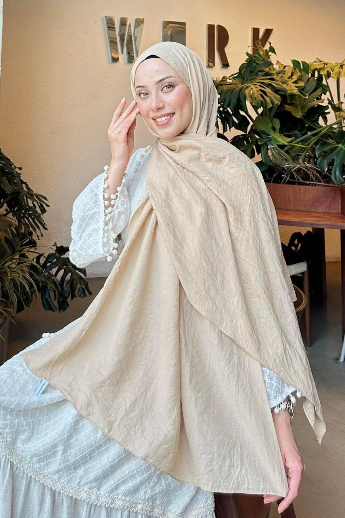 Comfort Cotton Hijab in beige styled with a white dress, seated view