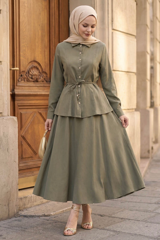 Woman in a hijab wearing the Ayla modest skirt set in sage: tie-waist button-front shirt and A-line maxi skirt, front view
