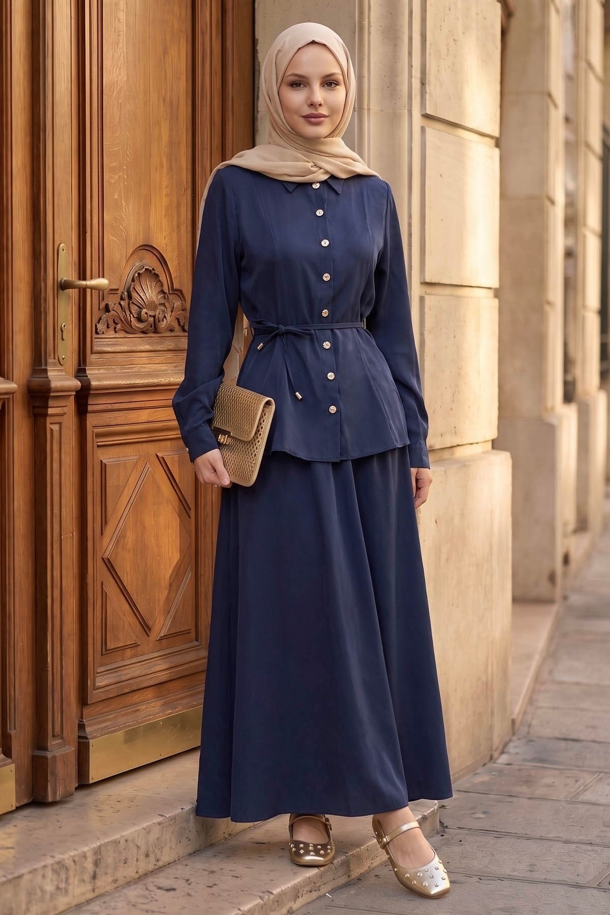 Ayla modest skirt set in navy styled with a woven clutch, front view