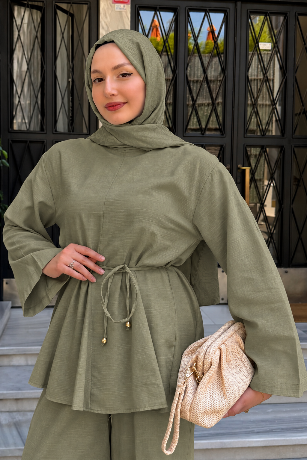 Close-up of the Willow cotton linen set in khaki green with tie waist, styled with a cream handbag