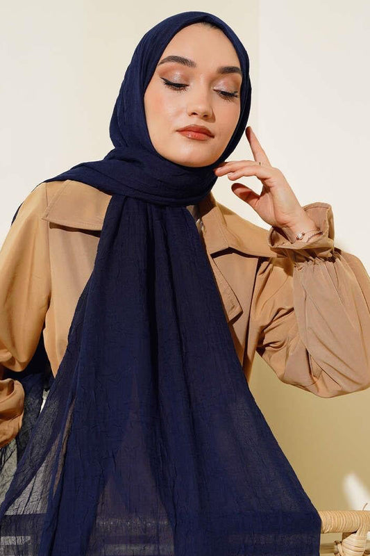 Front view of the MODESTIQUE Bamboo Crush Hijab in Navy, worn with a caramel trench coat.