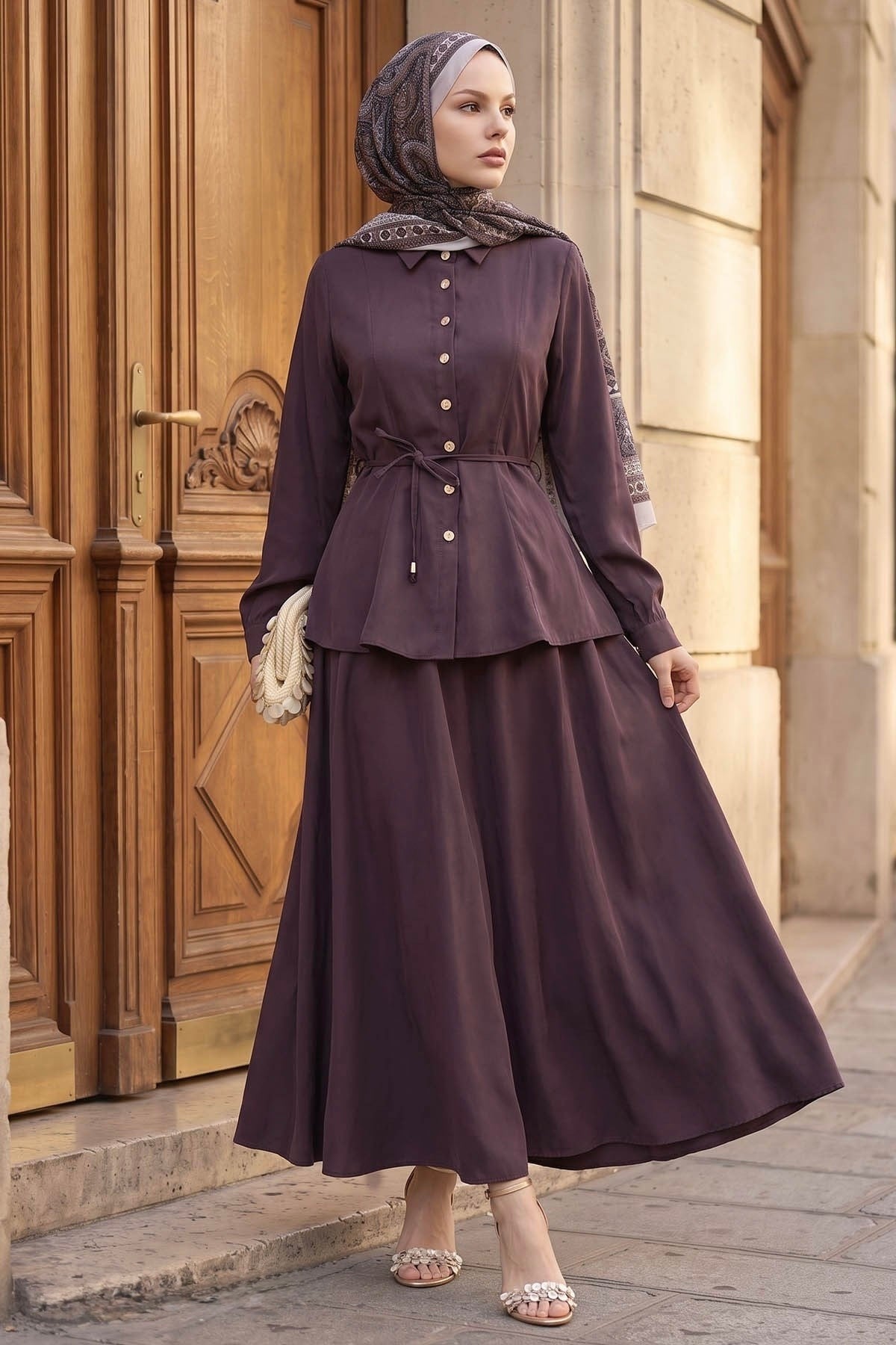 Ayla modest skirt set in burgundy styled with a clutch, front view