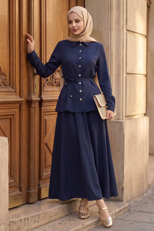 Woman in a hijab wearing the Ayla modest skirt set in navy: tie-waist button-front shirt and A-line maxi skirt