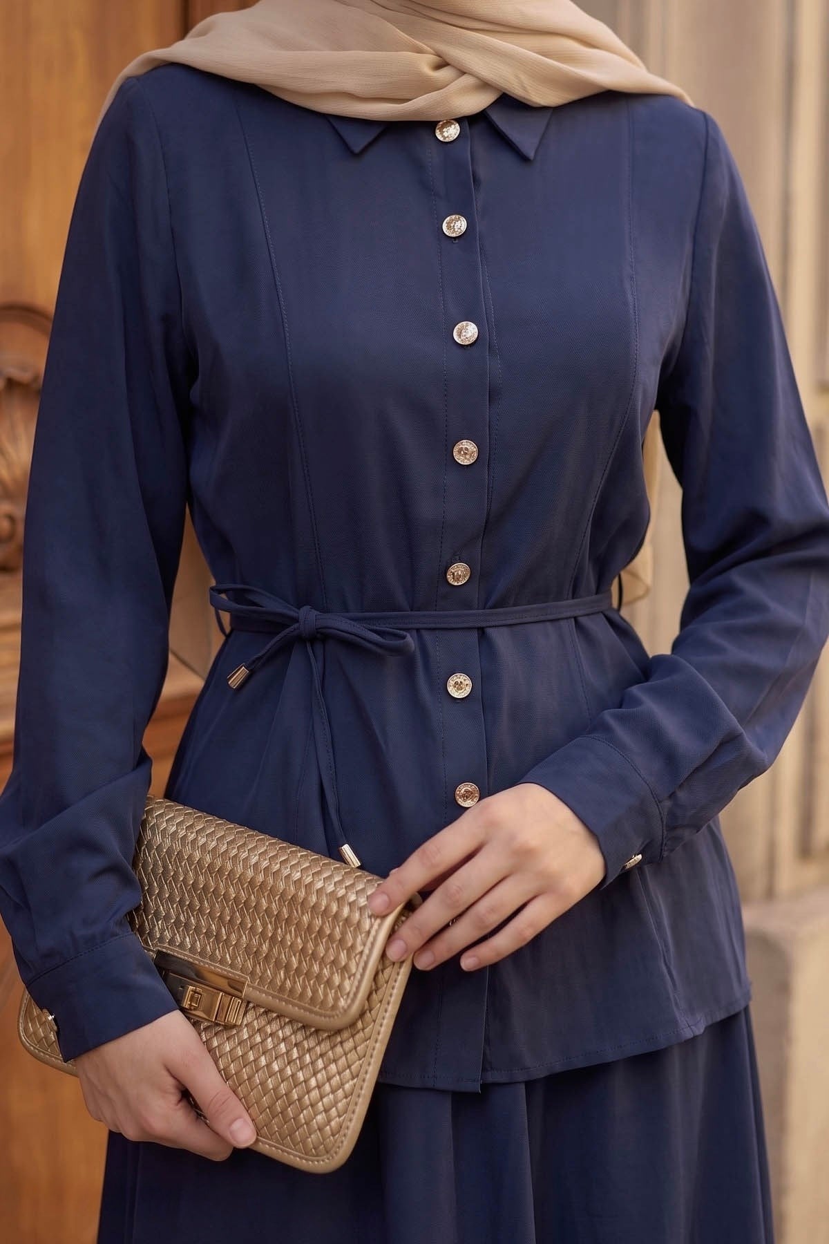 Close-up of the Ayla skirt set in navy showing the button-front shirt and tie waist