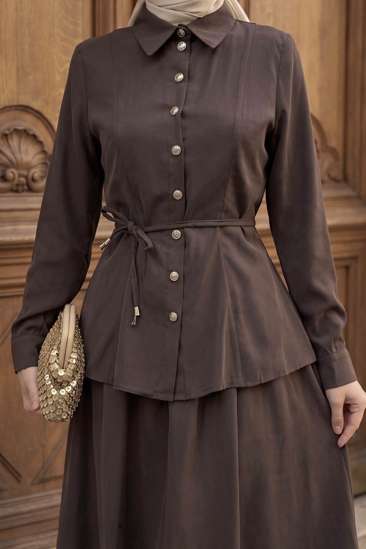 Close-up of the Ayla skirt set in brown showing the button-front shirt and tie waist