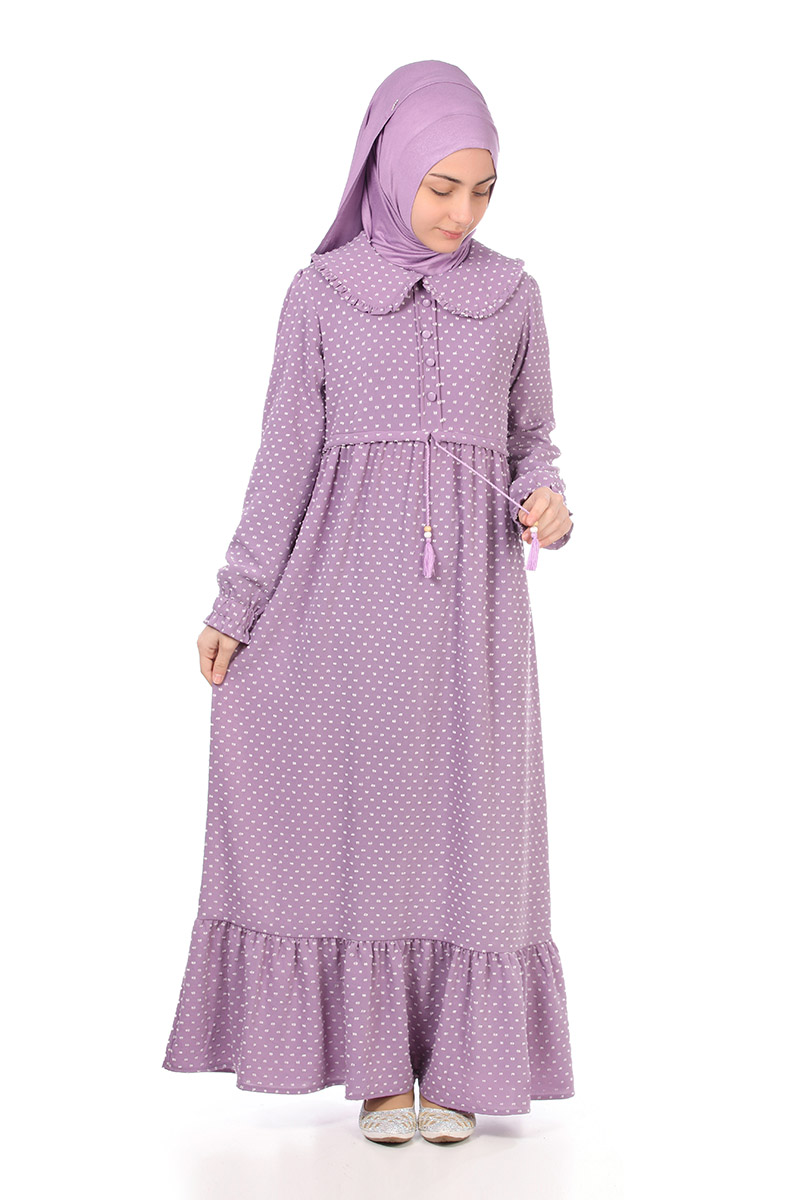 Model in a lilac hijab wearing the Zara girls' modest maxi dress in purple polka dot, front view