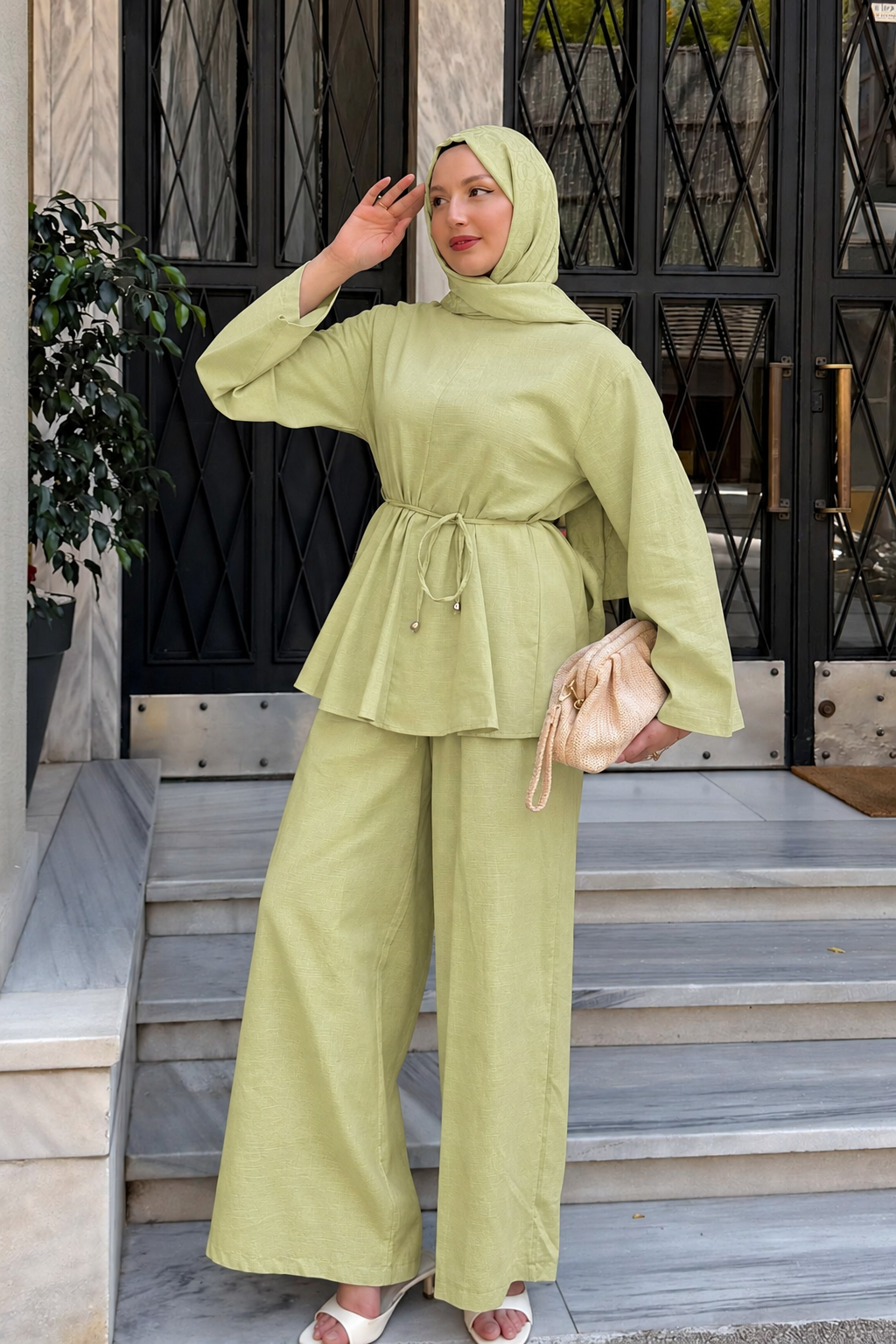 Woman in a hijab wearing the Willow cotton linen set in lime green: tie-waist top and relaxed wide-leg pants