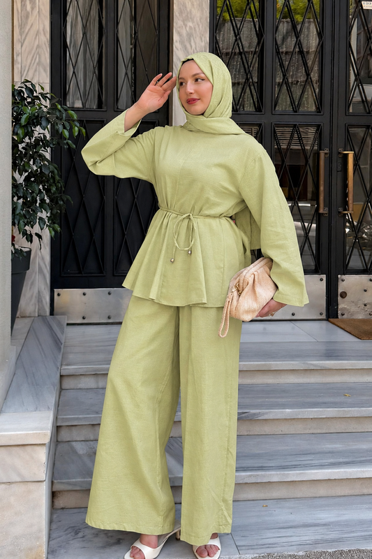 Woman in a hijab wearing the Willow cotton linen set in lime green: tie-waist top and relaxed wide-leg pants