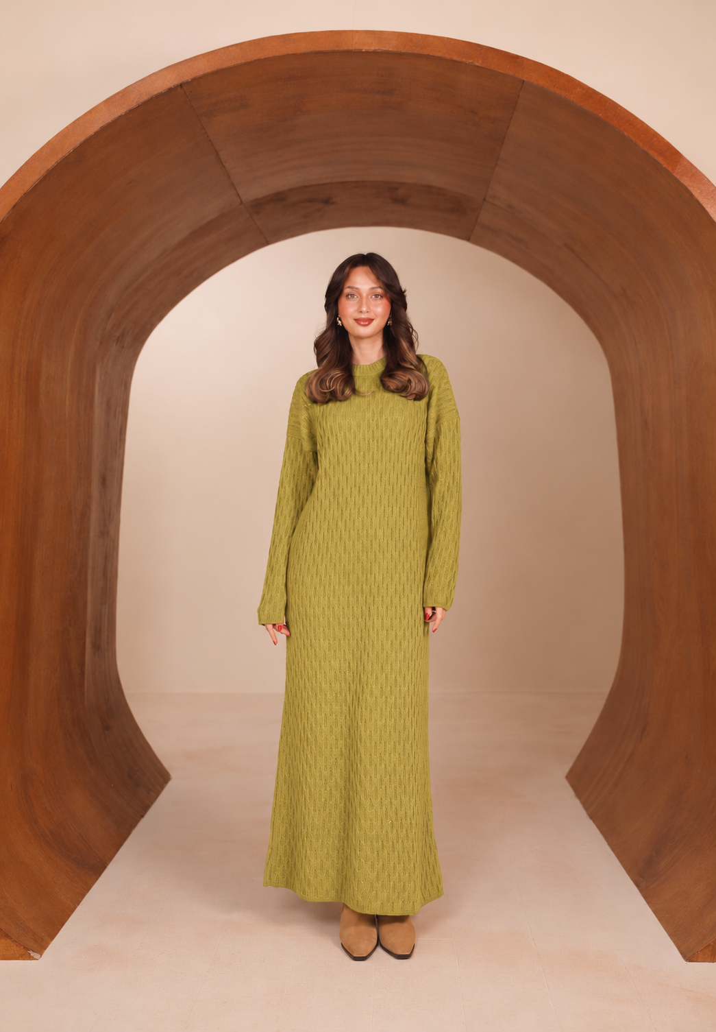 Woman wearing the Juniper long-sleeve collared knit maxi dress in olive green, front view