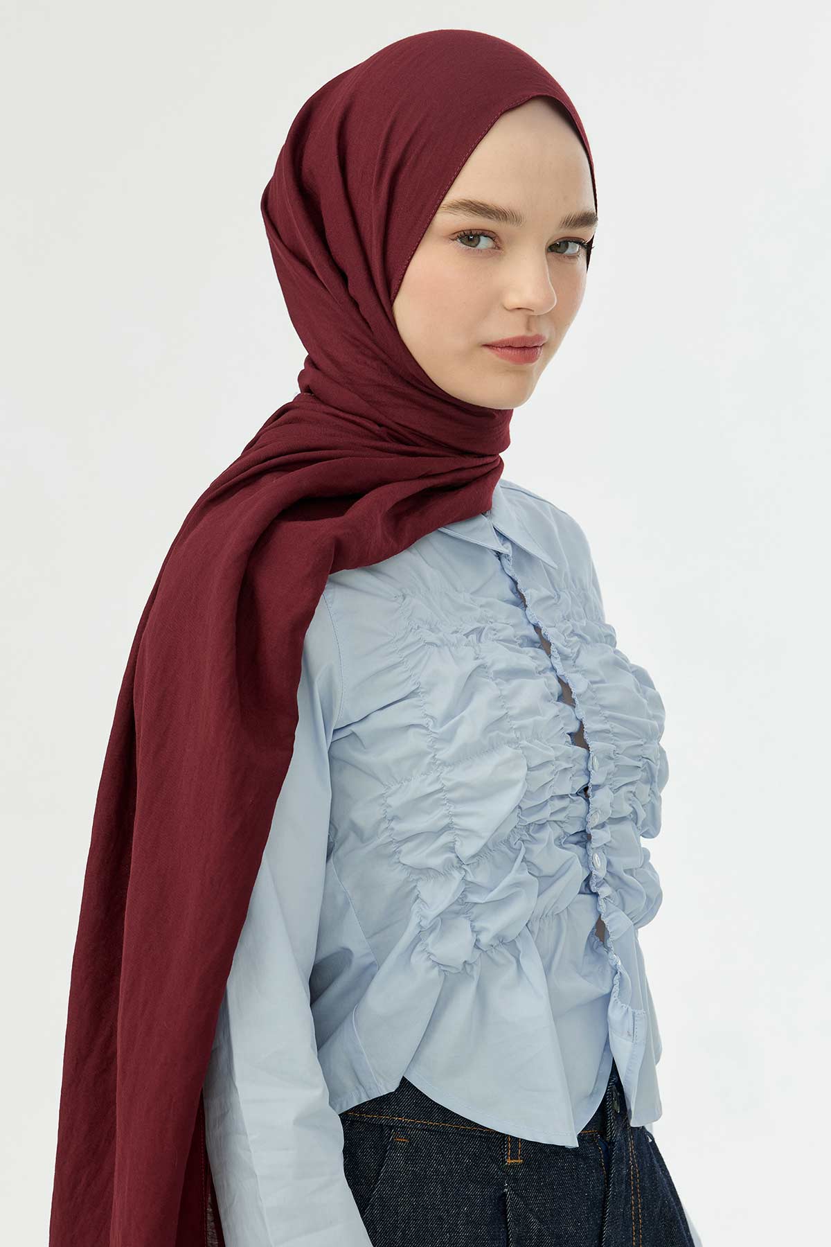 Maroon Comfort Cotton Hijab styled with a pale blue blouse, three-quarter view
