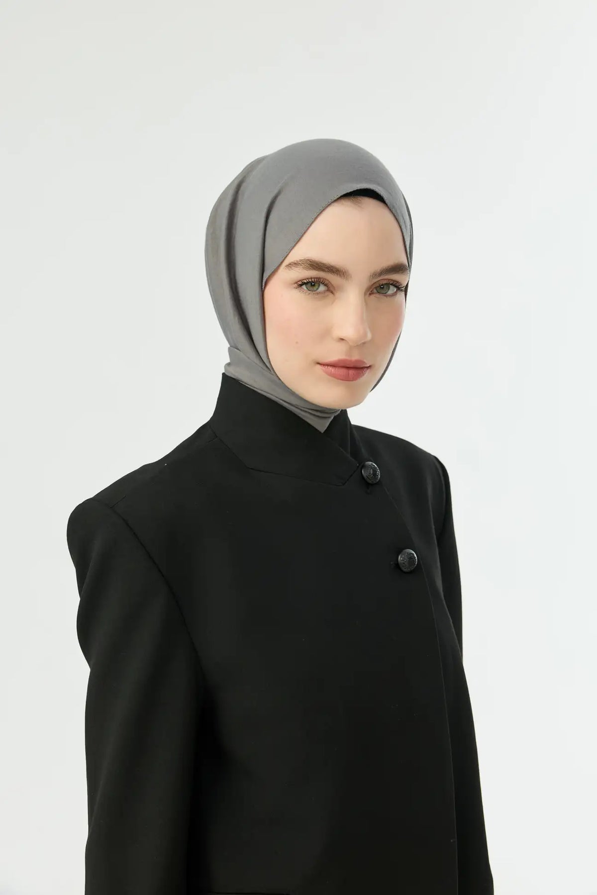 Grey Comfort Cotton Hijab with a black jacket, three-quarter view